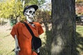 Halloween skeleton wearing a cap and bag