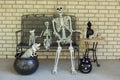 Halloween skeletons decorating a table and bench