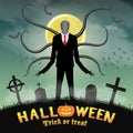 Halloween slender tall man in a night graveyard. Royalty Free Stock Photo
