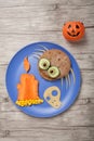 Halloween spider, candle and skull made of bread and vegetables