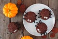 Halloween spider cupcakes, above view table scene over dark wood