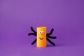 Halloween spider on purple for Halloween concept background. Paper crafts, easy DIY. Handcraft creative idea from toilet tube for