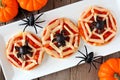 Halloween spider web mini pizzas, table scene on white plate Royalty Free Stock Photo