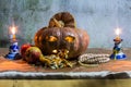 Halloween still life with pumpkins, apple, candles and rosary Royalty Free Stock Photo