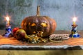 Halloween still life with pumpkins, apple, candles and rosary Royalty Free Stock Photo