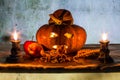 Halloween still life with pumpkins, apple, candles and rosary Royalty Free Stock Photo