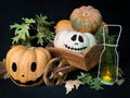 Halloween still life with a pumpkins in a wooden cart and a glowing candle Royalty Free Stock Photo