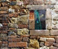 Halloween stone brick wall covered in spider web rags with a window looking on a scary horror forest with cabin and ghost witch Royalty Free Stock Photo