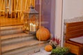 Halloween street decor. Stylish candle lantern and pumpkins on stairs, modern festive decoration of european city street. Happy