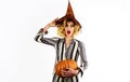 Halloween surprised witch with magic pumpkin. Beautiful woman in witches hat with Jack-o-lantern. Royalty Free Stock Photo