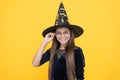 Halloween teen girl in witch hat and glasses look like wizard school pupil, happy halloween Royalty Free Stock Photo