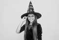 halloween teen girl in witch hat and glasses look like wizard school pupil, happy halloween