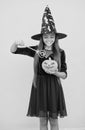 halloween teen girl in witch hat hold magic wand and pumpkin jack o lantern for witchcraft, happy halloween