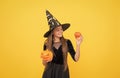 halloween teen girl in witch hat hold pumpkin jack o lantern for witchcraft, halloween traditions