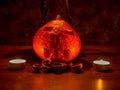 Halloween theme - pumpkin and walnut shells in the dark, lit by candles Royalty Free Stock Photo