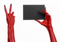 Halloween theme: Red devil hand with black nails holding a blank black card on a white background Royalty Free Stock Photo