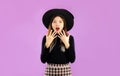 Halloween theme, young asian woman long hair wearing witch hat posing scary and surprised on purple background Royalty Free Stock Photo