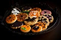Halloween-themed cookies on a black plate Royalty Free Stock Photo
