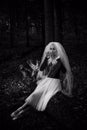 Halloween time, girl in white veil at forest Royalty Free Stock Photo