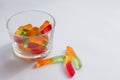 Halloween treats gummy worms in glass. Colorful jelly candies on white background. Top view Royalty Free Stock Photo