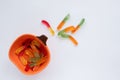 Halloween treats gummy worms in pumpkin bowl. Colorful jelly candies on white background. Top view Royalty Free Stock Photo