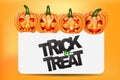 Halloween trick or treat background design. Sign with typography text and orange pumpkins with glowing faces. Royalty Free Stock Photo