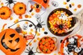 Halloween trick or treat scene with jack o lantern pails and assorted candy over white Royalty Free Stock Photo