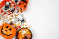 Halloween trick or treat side border with jack o lantern pails and assorted candy on a white background Royalty Free Stock Photo