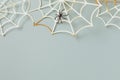 Halloween turquoise minimal background with spider web party decoration. Happy halloween holiday greeting card template