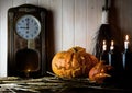 Halloween. Vintage interior in western style. candles, antique clock, broom and glowing pumpkin