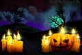Halloween vivid scary night backdrop - set of candles on the left and candle in pumpkin style on right side, lanterns in the dark