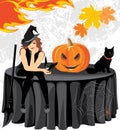 Halloween witch with a bat, cat and pumpkin sitting on the table Royalty Free Stock Photo