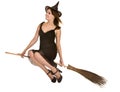 Halloween witch in black dress and hat on broom.