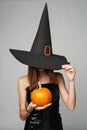 Halloween girl witch hat holding pumpkins in hand Royalty Free Stock Photo