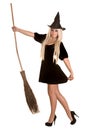 Halloween witch blond in black dress with broom. Royalty Free Stock Photo