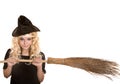 Halloween witch blond in black hat with broom. Royalty Free Stock Photo