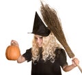 Halloween witch blond in hat and pumpkin, broom. Royalty Free Stock Photo