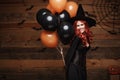 Halloween Witch Concept - Beautiful caucasian woman in witch costumes celebrating Halloween posing with posing with orange and bla Royalty Free Stock Photo