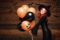 Halloween Witch Concept - Beautiful caucasian woman in witch costumes celebrating Halloween posing with posing with orange and bla Royalty Free Stock Photo