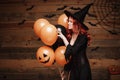 Halloween Witch Concept - Beautiful caucasian woman in witch costumes celebrating Halloween posing with posing with orange and bla Royalty Free Stock Photo