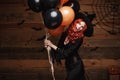 Halloween Witch Concept - Beautiful caucasian woman in witch costumes celebrating Halloween posing with posing with orange and bla Royalty Free Stock Photo