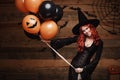 Halloween Witch Concept - Beautiful caucasian woman in witch costumes celebrating Halloween posing with posing with orange and bla Royalty Free Stock Photo