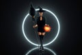 Halloween witch girl with a broom in her hands on the background of the moon. Beautiful young woman in a witch hat conjures. Royalty Free Stock Photo