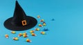 Halloween witch hat and candy corn on vibrant blue background Royalty Free Stock Photo