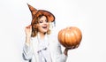 Halloween Witch in magic hat with jack-o-lantern. Smiling woman with Pumpkin. Happy holidays.