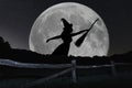 Halloween witch silhouette flying with broomstick. Full Moon. Royalty Free Stock Photo