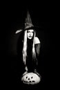 Halloween witch with a skull Royalty Free Stock Photo