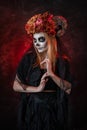 halloween witch skull calavera with horns, in a red dark room, looking at camera Royalty Free Stock Photo