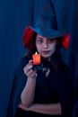 Halloween witch woman portrait holding candle, fashion young woman going to party with spooky costume, makeup scary faces, having