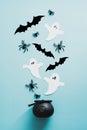 Halloween witchcraft potion with spiders, ghosts, bats on blue background. Flat lay, top view, overhead